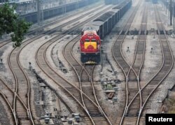 FILE - A freight train arrives in Dazhou, China, June 18, 2017.