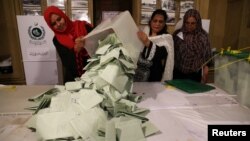 Election officials count ballots after polls closed during the general election in Islamabad, Pakistan, July 25, 2018.