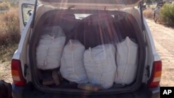 In this Jan. 25, 2018 photo released by Mexico's National Security Commission, packages containing illegal drugs are seen inside a sports utility vehicle near Ensenada, Baja California, Mexico. 