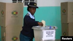 A member of the Zimbabwean police force casts her vote in the capital, Harare, July 14, 2013. 