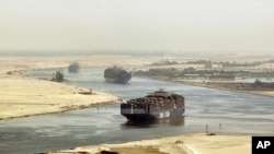 FILE - cargo ships sail through the Suez Canal near Ismailia, Egypt. 