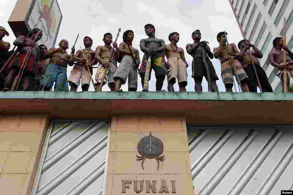 Members of different Amazonian tribes occupy the headquarters of Brazil&#39;s Indian Affairs Bureau as they protest a court decision to evict them from a nearby plot of land they have been occupying for several weeks, in Manaus, Sept. 19, 2013. 