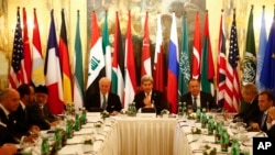 Russia's Foreign Minister Sergei Lavrov, top right, U.S. Secretary of State John Kerry, top center, and other foreign ministers attend a meeting in Vienna, Austria, Nov. 14, 2015, to find a way to resolve the conflict in Syria. 