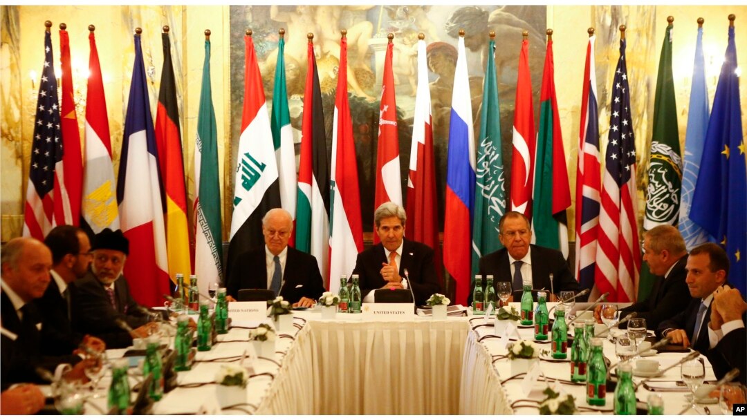 FILE - Russia's Foreign Minister Sergei Lavrov, top right, U.S. Secretary of State John Kerry, top center, and other foreign ministers attend a meeting in Vienna, Austria, Nov. 14, 2015, to find a way to resolve the conflict in Syria.