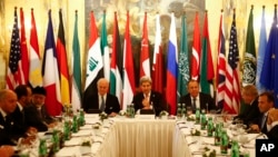 FILE - Russia's Foreign Minister Sergei Lavrov, top right, U.S. Secretary of State John Kerry, top center, and other foreign ministers attend a meeting in Vienna, Austria, Nov. 14, 2015, to find a way to resolve the conflict in Syria.