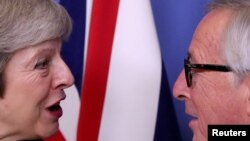 FILE - British Prime Minister Theresa May meets with European Commission President Jean-Claude Juncker to discuss Brexit, at the EU headquarters in Brussels, Dec. 11, 2018.