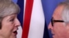 FILE - British Prime Minister Theresa May meets with European Commission President Jean-Claude Juncker to discuss Brexit, at the EU headquarters in Brussels, Dec. 11, 2018.