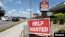 FILE - A Brandon Motor Lodge displays a "Help Wanted" sign in Brandon, Florida, June 1, 2021.