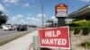 FILE - A Brandon Motor Lodge displays a "Help Wanted" sign in Brandon, Florida.