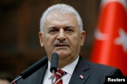 Prime Minister Binali Yildirim addresses members of parliament at the Turkish parliament in Ankara, Nov. 8, 2016.