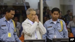 Former Khmer Rouge prison chief Kaing Kek Iev alias Duch (C) greets the court during his appeal hearing at the Court Room of the Extraordinary Chambers in the Courts of Cambodia on the outskirts of Phnom Penh, February 3, 2012.