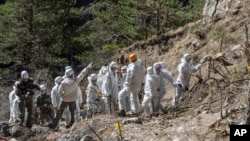 French emergency rescue services work among debris of the Germanwings passenger jet at the crash site near Seyne-les-Alpes, France, April 3, 2015.