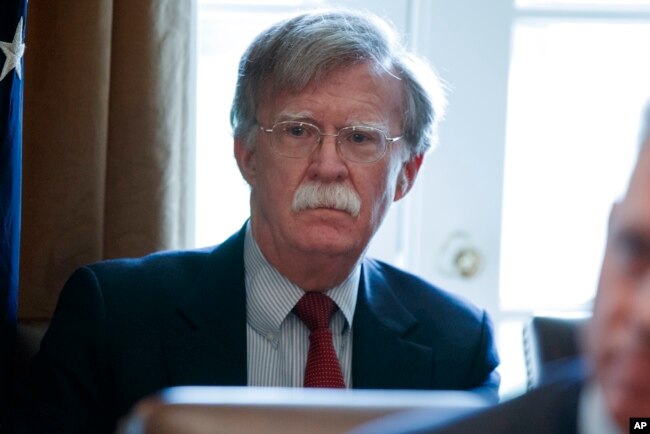 National Security Adviser John Bolton listens as President Donald Trump speaks during a Cabinet meeting at the White House in Washington, April 9, 2018.