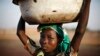 FILE - A Ghanaian girl waits to sell water in the northern city of Tamale. 
