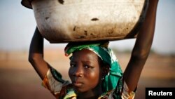 FILE - A Ghanaian girl waits to sell water in the northern city of Tamale. 