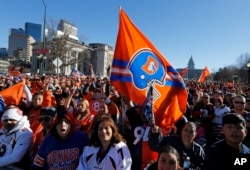 Broncos fans cheer after arriving early to await the start of a victory rally to celebrate the Broncos' win over the Carolina Panthers in Super Bowl 50, in Denver, Feb. 9, 2016.