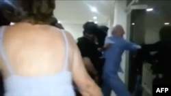 A screen grab from cellphone footage shows opposition leader Antonio Ledezma being taken away from his home forcibly by the intelligence service while still wearing pajamas, in Caracas, July 31, 2017.