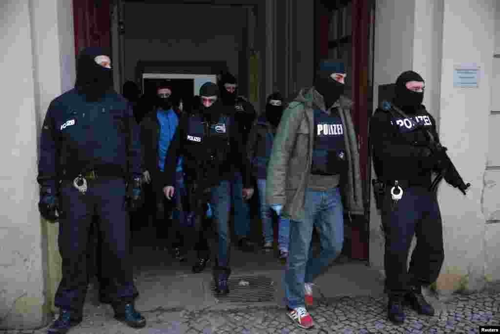 German special police units leave an apartment building in the Wedding district of Berlin, Germany, Jan. 16, 2015.