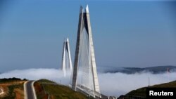 FILE - Yavuz Sultan Selim bridge covered by fog over the Bosphorus, Istanbul, April 27, 2017. 