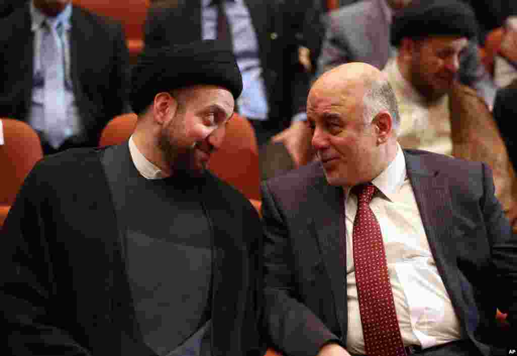 Iraq&#39;s incoming Prime Minister Haider al-Abadi, right, and Ammar al-Hakim, the leader of the Supreme Islamic Council of Iraq, during the session to approve the new government in Baghdad, Iraq, Sept. 8, 2014.