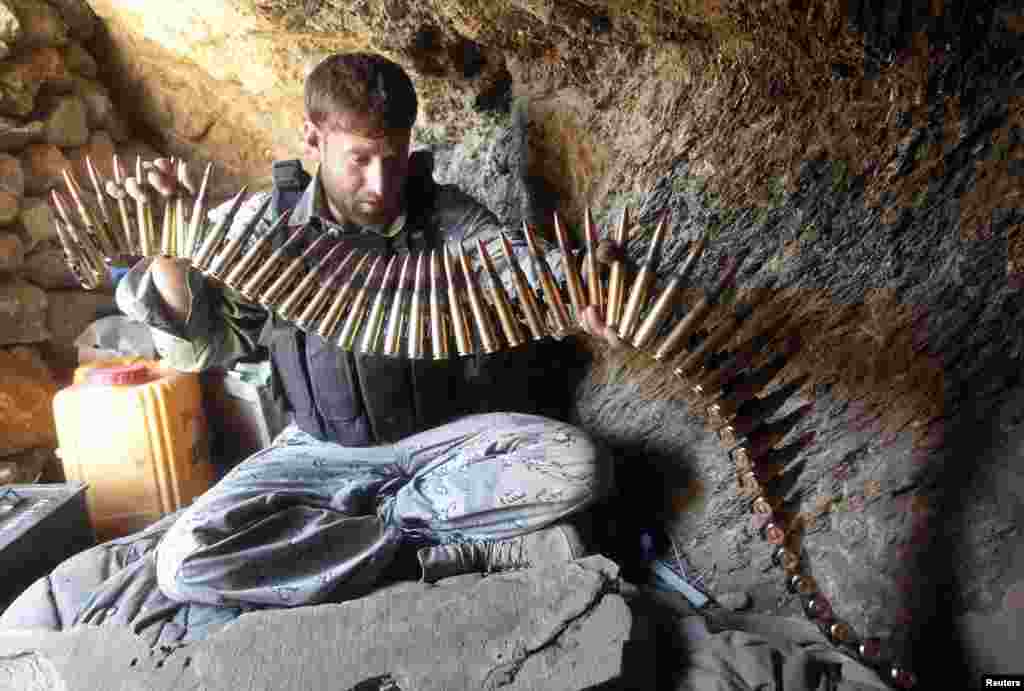 An Afghan border policeman prepares ammunition at a check post at the Goshta district of Nangarhar province, where Afghanistan shares borders with Pakistan. 