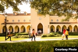 Students walk across campus at Rollins College in Winter Park, Florida.