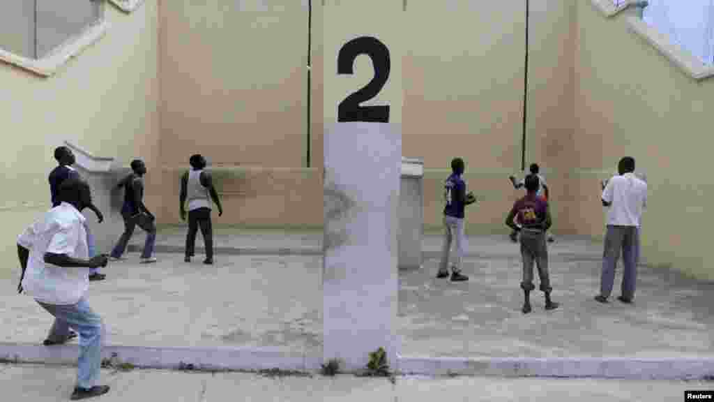 Youths play Eton fives game in a court in Kano.
