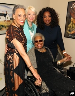 FILE: At Maya Angelou’s portrait unveiling at the Smithsonian’s National Portrait Gallery, the writer, seated, is joined by, from left, National African Art Museum director Johnnetta Cole, National Portrait Gallery director Kim Sajet and Oprah Winfrey in Washington, D.C., in April 2014.