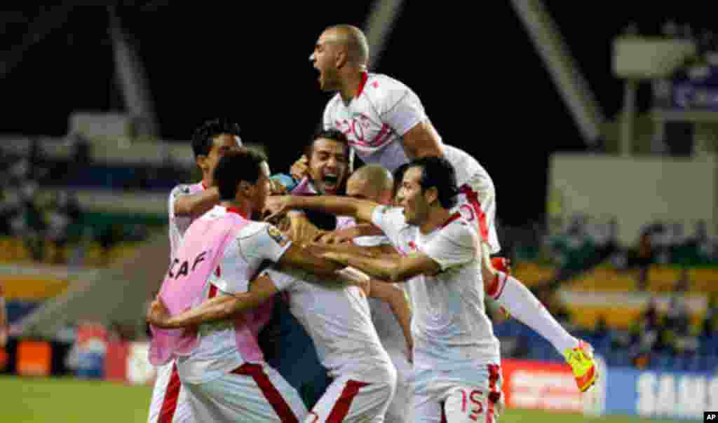 Tunisia's players celebrate after defeating Morocco during their African Cup of Nations soccer match in Libreville