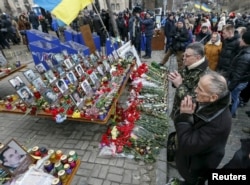 People attend a commemoration ceremony at the site where anti-Viktor Yanukovich protesters were killed during clashes in 2014 in Kiev, Ukraine, Feb. 20, 2016.