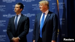 FILE - Then U.S. Republican presidential candidate Donald Trump welcomes his son Donald Trump Jr. to the stage at one of the New England Council's "Politics and Eggs' breakfasts in Manchester, New Hampshire, Nov. 11, 2015.