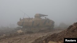 A Turkish military tank is seen near Mount Barsaya, northeast of Afrin, Syria, Jan. 23, 2018. Five Turkish soldiers died Saturday in the Afrin area when their tank was attacked.