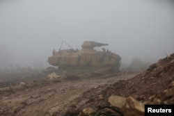 FILE - A Turkish military tank is seen near Mount Barsaya, northeast of Afrin, Syria, Jan. 23, 2018. Five Turkish soldiers died Saturday in the Afrin area when their tank was attacked.