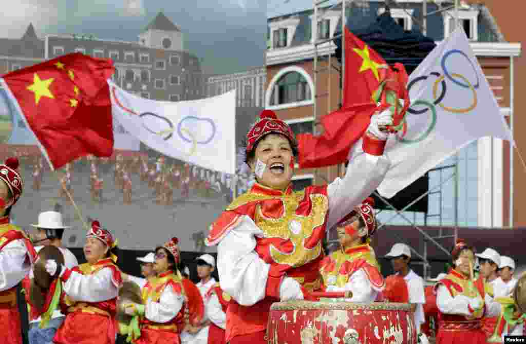 Local residents perform ahead of the International Olympic Committee's announcement of the winning city for the 2022 Winter Olympics bid, at a square in Chongli county of Zhangjiakou, jointly bidding to host the Games with China's capital, Beijing. Beijing becomes the first city to be awarded both summer and winter Games.