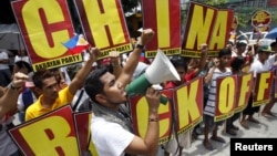 Filipinos chant anti-China slogans over the disputed Scarborough Shoal islands in the South China Sea claimed by both nations as they march toward the Chinese consulate in the Makati financial district of Manila, Philippines, May 11, 2012. 