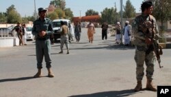 Security forces guard near Abdul Jabar Qahraman's house, a parliamentary election candidate, after he was killed in an explosion inside his home in Lashkar Gah, Afghanistan, Wednesday, Oct. 17, 2018.