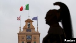 A member of the Italian elite military unit Cuirassiers' Regiment, who are honor guards for the Italian president, stands guard prior to Carlo Cottarelli's meeting with Italy's President Sergio Mattarella at the Quirinal Palace in Rome, Italy, May 29, 2018.