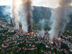 Fires burn in the town of Thantlang in Myanmar's northwestern state of Chin, Oct. 29, 2021. More than 160 buildings in the town in the northwestern Myanmar, including three churches, have been destroyed by shelling by government troops.