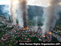 Fires burn in the town of Thantlang in Myanmar's northwestern state of Chin, Oct. 29, 2021. More than 160 buildings in the town in the northwestern Myanmar, including three churches, have been destroyed by shelling by government troops.