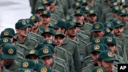 FILE - Iranian Revolutionary Guard members arrive for a ceremony celebrating the 40th anniversary of the Islamic Revolution at the Azadi, or Freedom, Square in Tehran, Iran, Feb. 11, 2019.