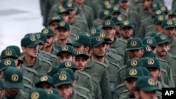 FILE - Iranian Revolutionary Guard members arrive for a ceremony celebrating the 40th anniversary of the Islamic Revolution, at the Azadi, or Freedom, Square, in Tehran, Iran, Feb. 11, 2019.
