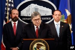 Attorney General William Barr speaks alongside Deputy Attorney General Rod Rosenstein, right, and acting Principal Associate Deputy Attorney General Edward O'Callaghan about the release of a redacted version of special counsel Robert Mueller's report during a news conference at the Department of Justice in Washington, April 18, 2019.