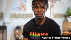 FILE - A LGBT activist wearing a Ghana pride shirt poses for a photo in a safe house, Nov. 8, 2021. Hearings are currently being held on proposed legislation that would make it a crime to be gay, bisexual or transgender in Ghana.