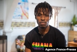 FILE - A LGBTQ activist wearing a Ghana Pride shirt poses for a photo in a safe house, November 8, 2021.