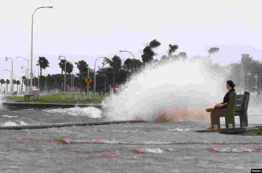 New Orleans resident Diana Whipple watches waves crash on the shore of Lake Pontchartrain as Tropical Storm Isaac approaches New Orleans, Louisiana, August 28, 2012.