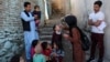 FILE - A health worker administers a polio vaccine to a child in Kabul, Afghanistan, March 29, 2021. 