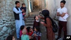 FILE - A health worker administers a polio vaccine to a child in Kabul, Afghanistan, March 29, 2021. 