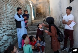 FILE - A health worker administers a polio vaccine to a child in Kabul, Afghanistan, March 29, 2021.