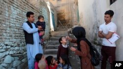 FILE - A health worker administers a polio vaccine to a child in Kabul, Afghanistan, March 29, 2021. 