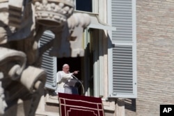 Pope Francis delivers his speech during the Angelus noon prayer he delivered from the window of his studio overlooking St. Peter's Square at the Vatican, Jan. 1, 2015.